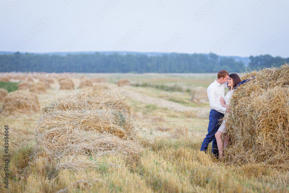 Couple at rural haystacks
