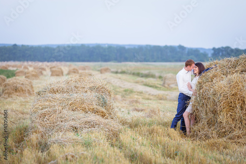 Couple at rural haystacks