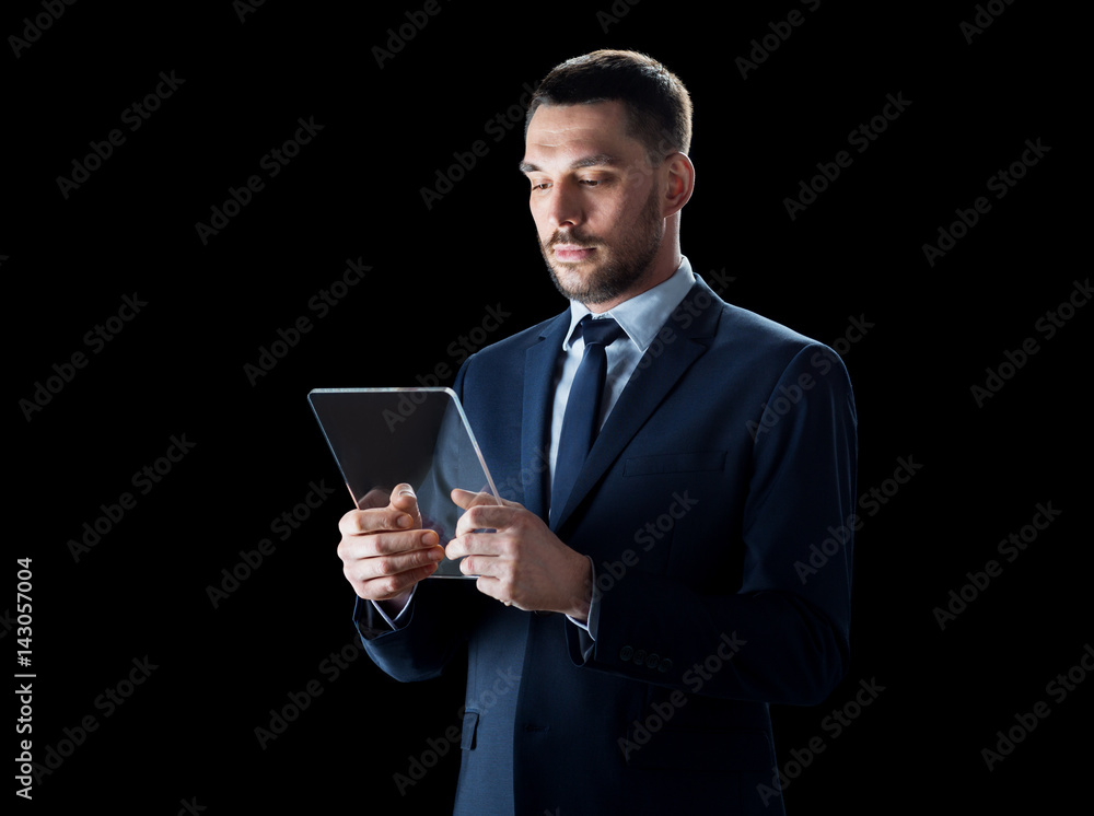 businessman in suit with transparent tablet pc businessman in suit with transparent tablet pc
