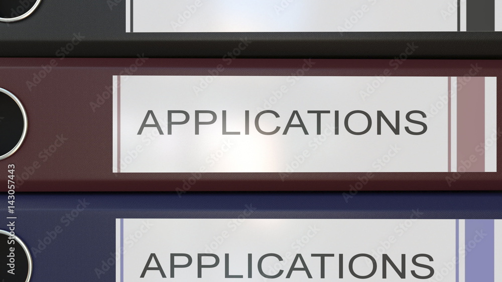 Vertical stack of multicolor office binders with Applications tags 3D rendering Vertical stack of multicolor office binders with Applications tags 3D rendering