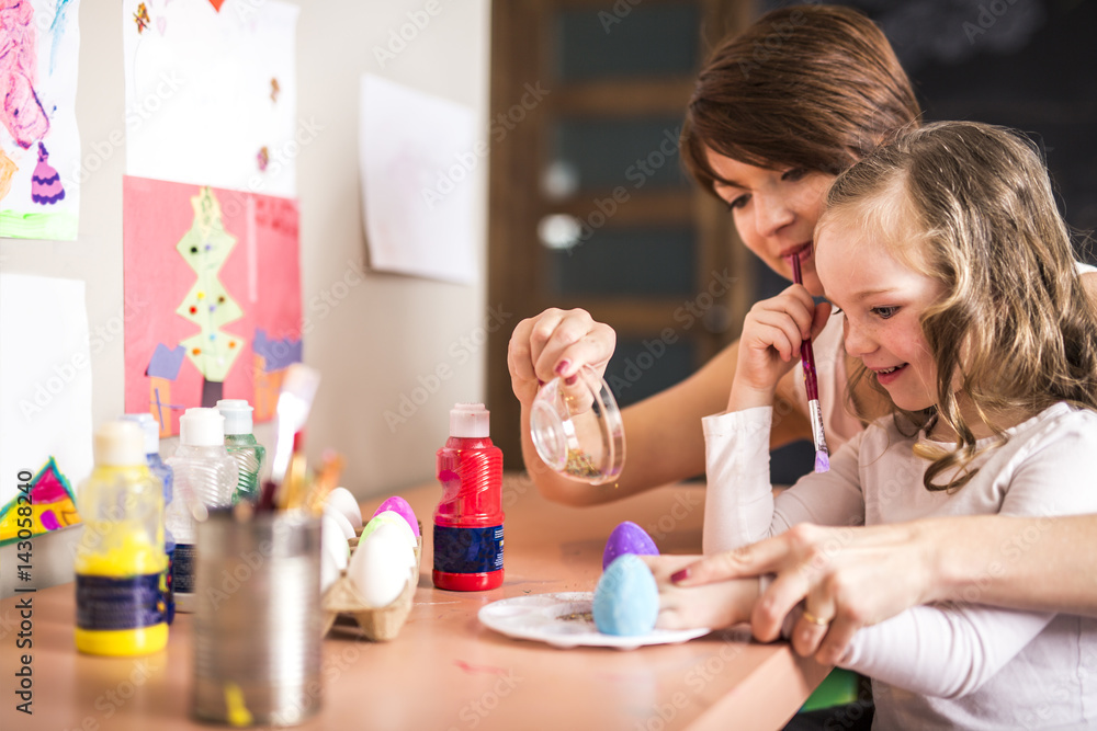 Happy easter A beautiful child girl painting Easter eggs. Happy family preparing for Easter. Happy easter A beautiful child girl painting Easter eggs. Happy family preparing for Easter.