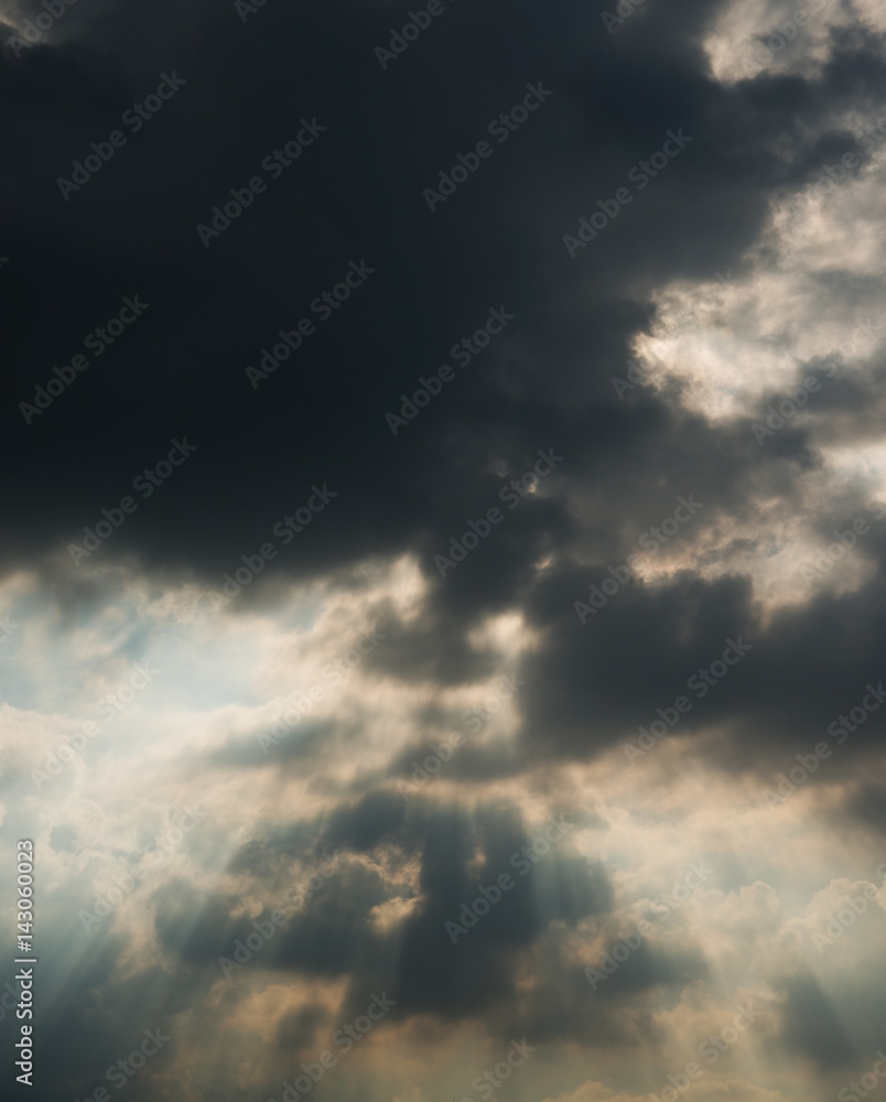 Light rays shine through the  clouds