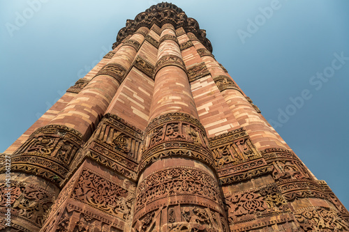Qutub Minar close up with red sandstone carvings on the pillar walls. Qutb Minar is a UNESCO World heritage site at Delhi India.