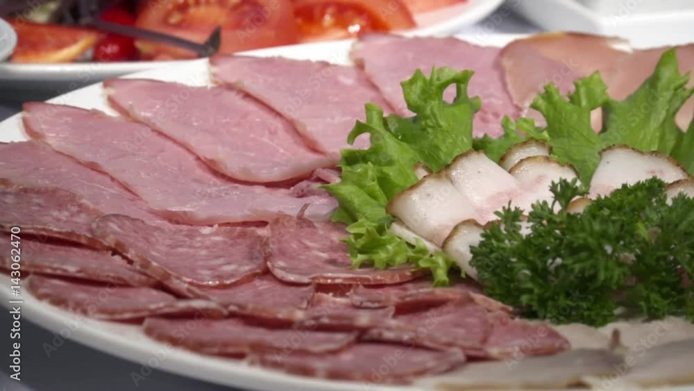Meat cold cuts on the plate in the restaurant Meat cold cuts on the plate in the restaurant