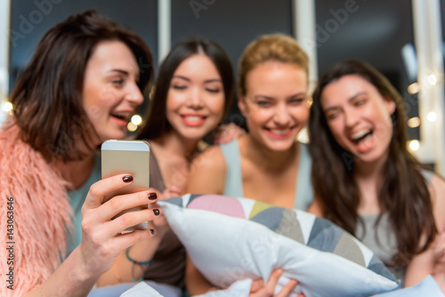 Cheerful girls doing image at mobile