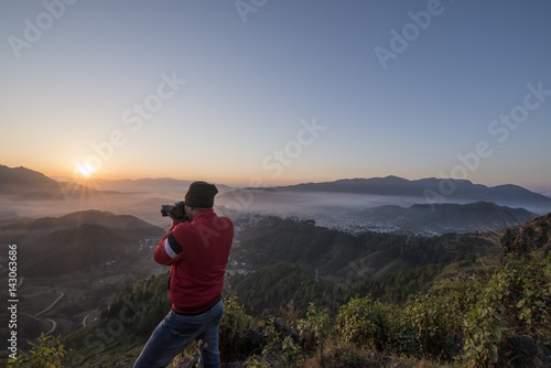 Photographer in action  clicking a beautiful Himalayan Sunrise.
