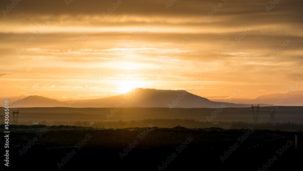Sun rising behind a mountain