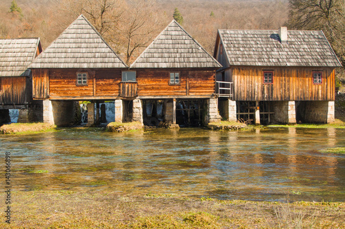      Old wooden water mills in on Majerovo vrilo, source of Gacka river, Lika, Croatia 