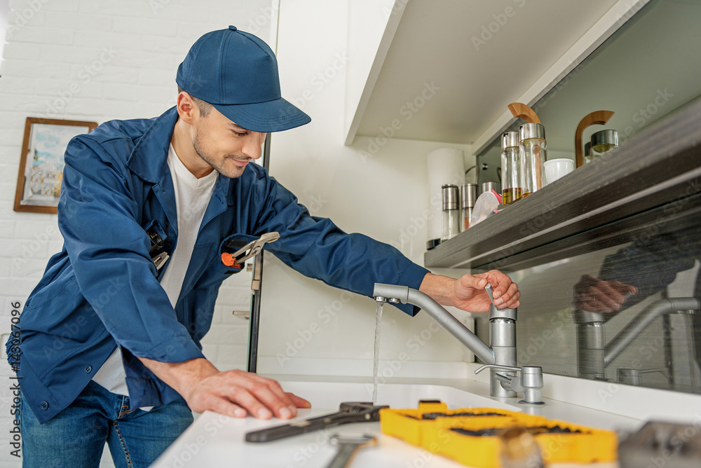 Careful smiling man in kitchen Careful smiling man in kitchen