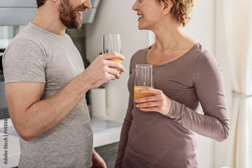 Joyful man and woman enjoying healthy beverage Joyful man and woman enjoying healthy beverage