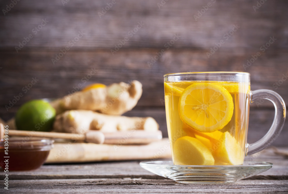 Ginger tea and ingredients on a grunge wooden background Ginger tea and ingredients on a grunge wooden background