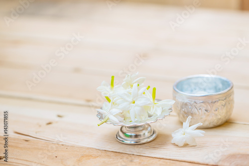 Thailand Songkran festival decoration concept, water in silver bowl with jasmine white flower.