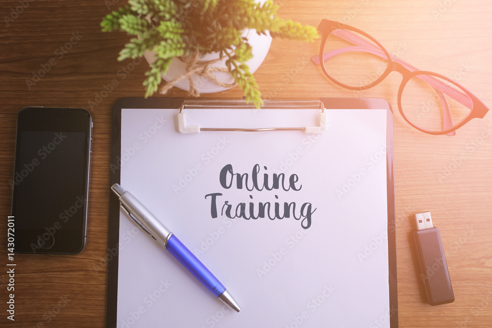Fototapeta premium Business concept - Top view notebook writing Online Training.