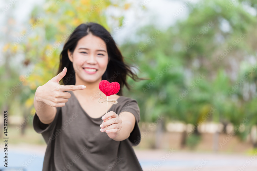 Asian woman hand hold beautiful red heart sweet loving symbol of take care or charity help to you. Asian woman hand hold beautiful red heart sweet loving symbol of take care or charity help to you.