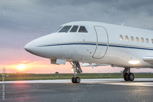 Large private business jet on runway, ready for takeoff, during sunrise © Dimitrije Ostojic