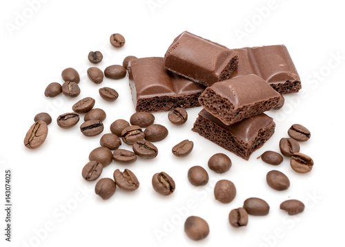 Chocolate slices and coffee beans on a white background. Photo for your catalog or store.