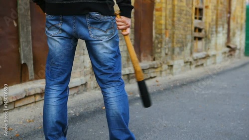 street hooligan is holding a baseball bat