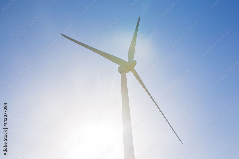 Green renewable energy concept - wind generator turbines in sky Green renewable energy concept - wind generator turbines in sky