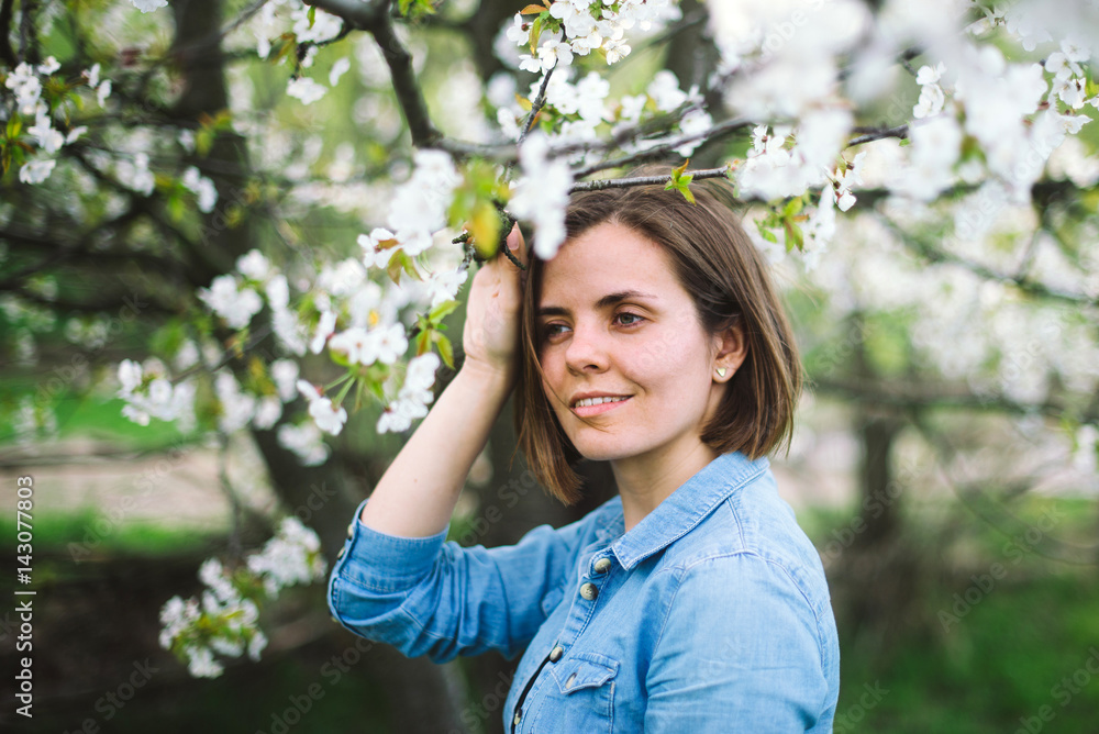 Beautiful smiling girl in a flowering garden Beautiful smiling girl in a flowering garden