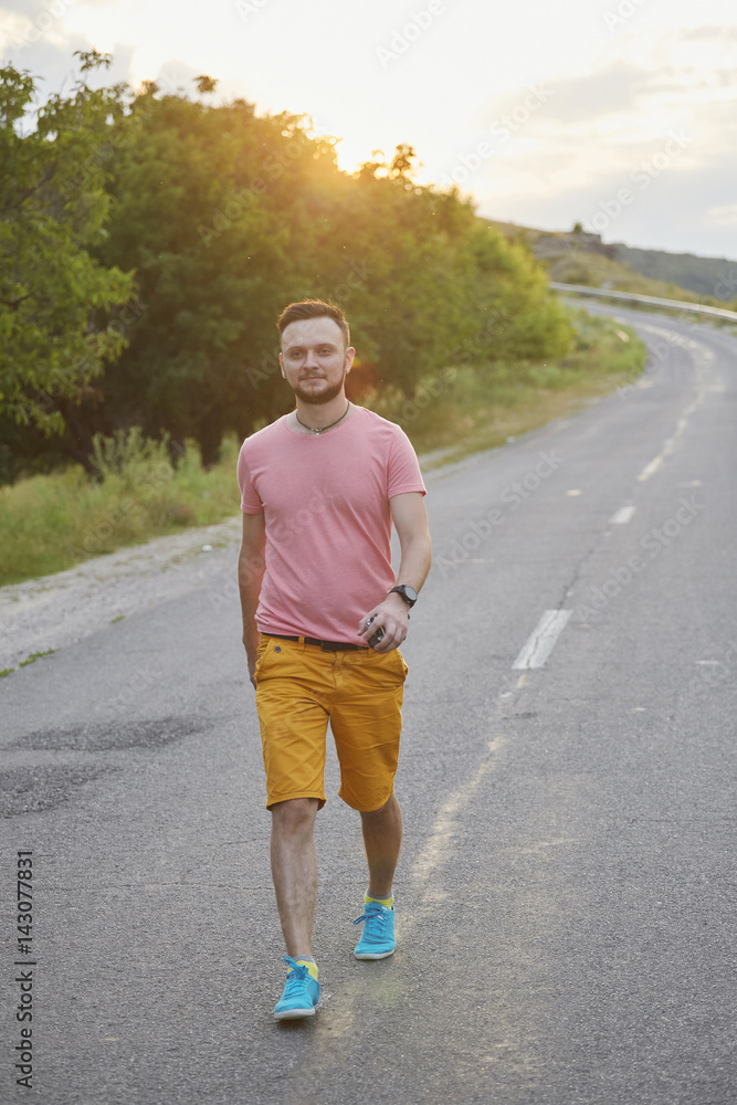 Young man smiling and enjoying sunny summer day