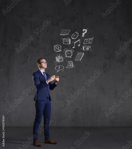 Businessman checking his smartphone on a dark dramatic background. Business, office, idea concept.