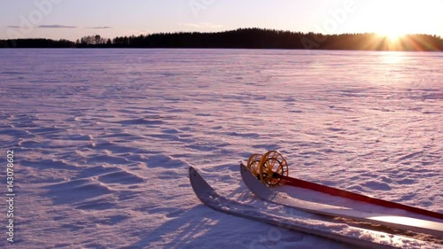 Wooden off-track skis laying on snow