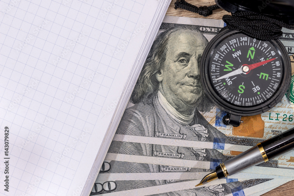 compass on usa hundred dollars with note, pen. journey concept. compass on usa hundred dollars with note, pen. journey concept.