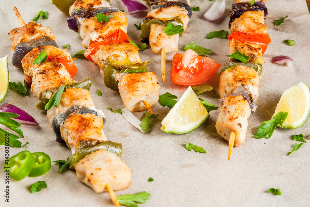 Fajita chicken kebabs, with chicken meat, pepper, chili, tomatoes, onions, lime juice and herbs. In a frying pan, on a rustic wooden table. Mexican cuisine, a traditional food, Fajita chicken kebabs, with chicken meat, pepper, chili, tomatoes, onions, lime juice and herbs. In a frying pan, on a rustic wooden table. Mexican cuisine, a traditional food,