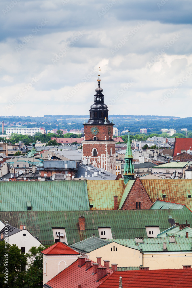 Beautiful high gothic town hall tower with clock in the main Market Square in Cracow, Poland. Travel Europe. Aerial view. Panorama of city Beautiful high gothic town hall tower with clock in the main Market Square in Cracow, Poland. Travel Europe. Aerial view. Panorama of city