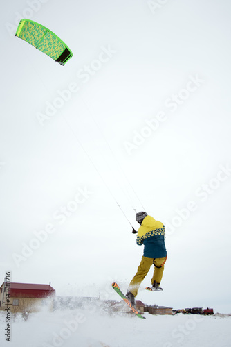 extreme freestyle ski jump with young man at winter season. snowkiting. photo