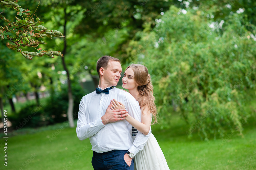 A married couple is walking and hugging in the park. A married couple is walking and hugging in the park.