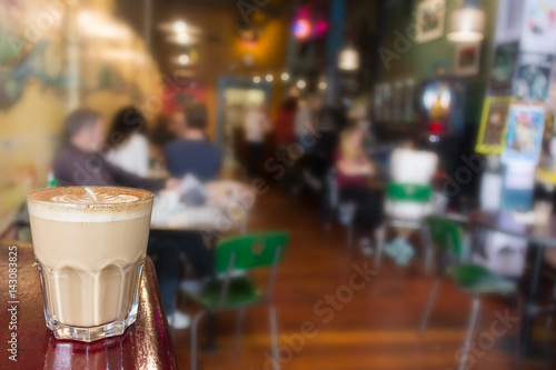A cappuccino on transparent glass.