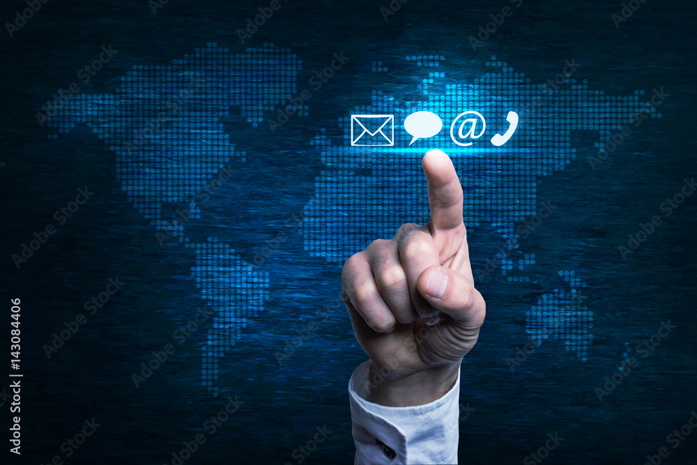Hand pressing contact icon over world map. Hand pressing contact icon over world map.