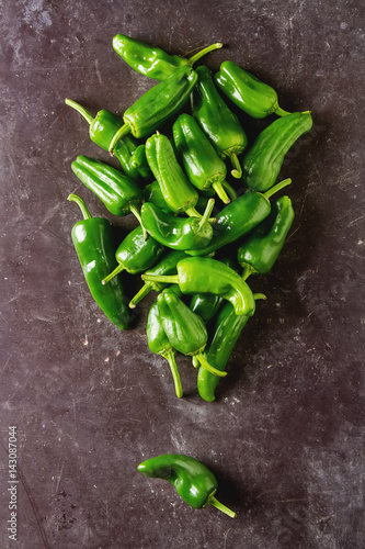 Green  fresh jalapeno peppers. Spicy Mexican food. Dark background.