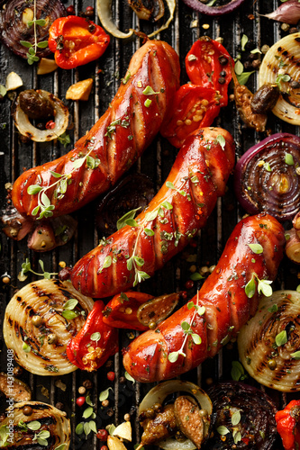 Grilled sausages and vegetables with addition spices and fresh herbs