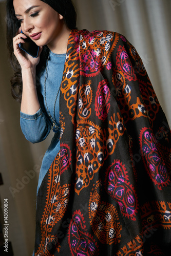 Bilde på lerret Portrait of a beautiful brunette talking on the phone