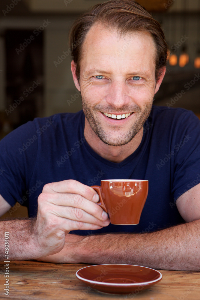 handsome man drinking coffee and smiling handsome man drinking coffee and smiling