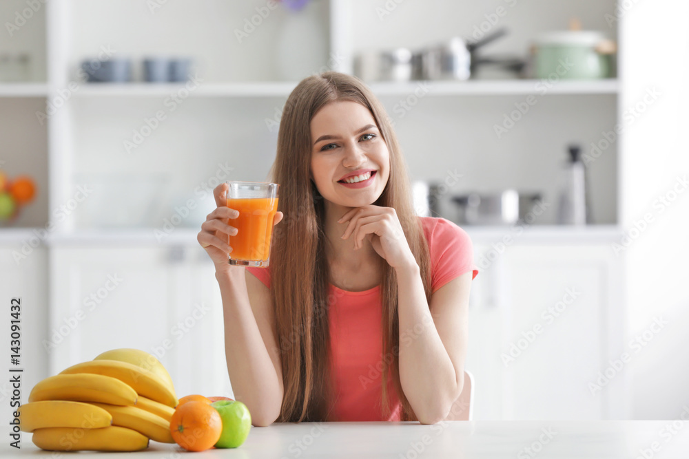 Young woman tasting fresh juice at kitchen Young woman tasting fresh juice at kitchen