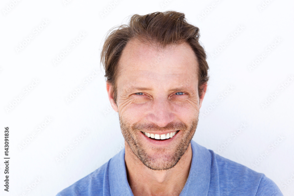 Close up happy older man smiling against white background Close up happy older man smiling against white background