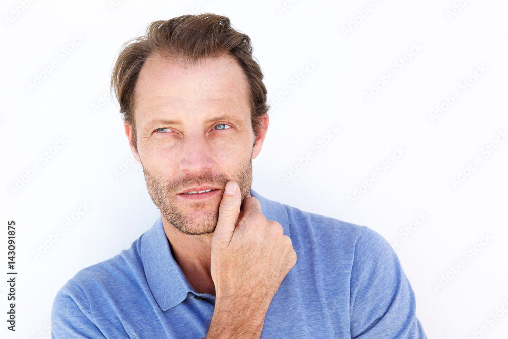 Close up handsome man thinking with hand on chin Close up handsome man thinking with hand on chin