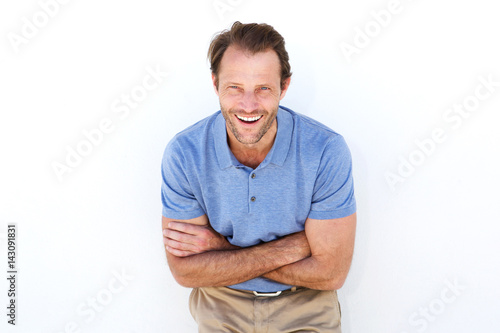 male fashion model laughing against white wall
