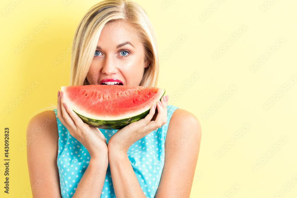 Happy young woman holding watermelon Happy young woman holding watermelon