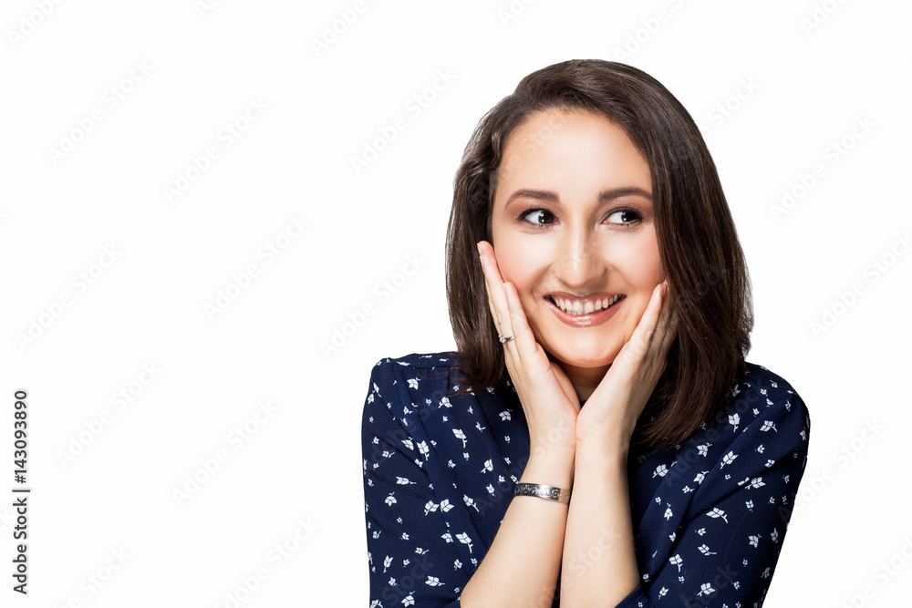 beautiful brunette girl with short hair in a blue dress hands on the cheeks of the face with a smile looking at the camera laughing emotions isolate white background beautiful brunette girl with short hair in a blue dress hands on the cheeks of the face with a smile looking at the camera laughing emotions isolate white background