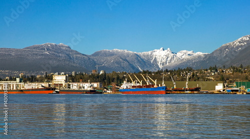 
The ship under loading in the port of North Vancouver on the  mountains background