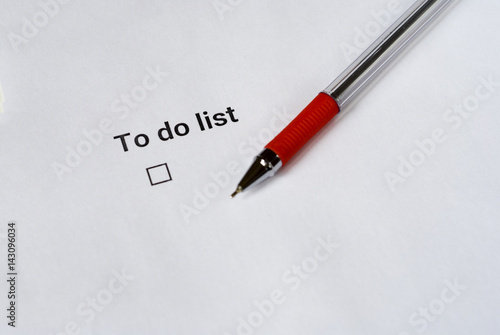 To do list with red pen on white paper