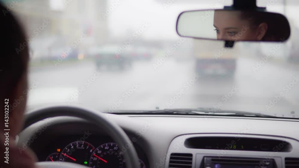 Young attractive woman rides behind the wheel of a car. 4K Young attractive woman rides behind the wheel of a car. 4K