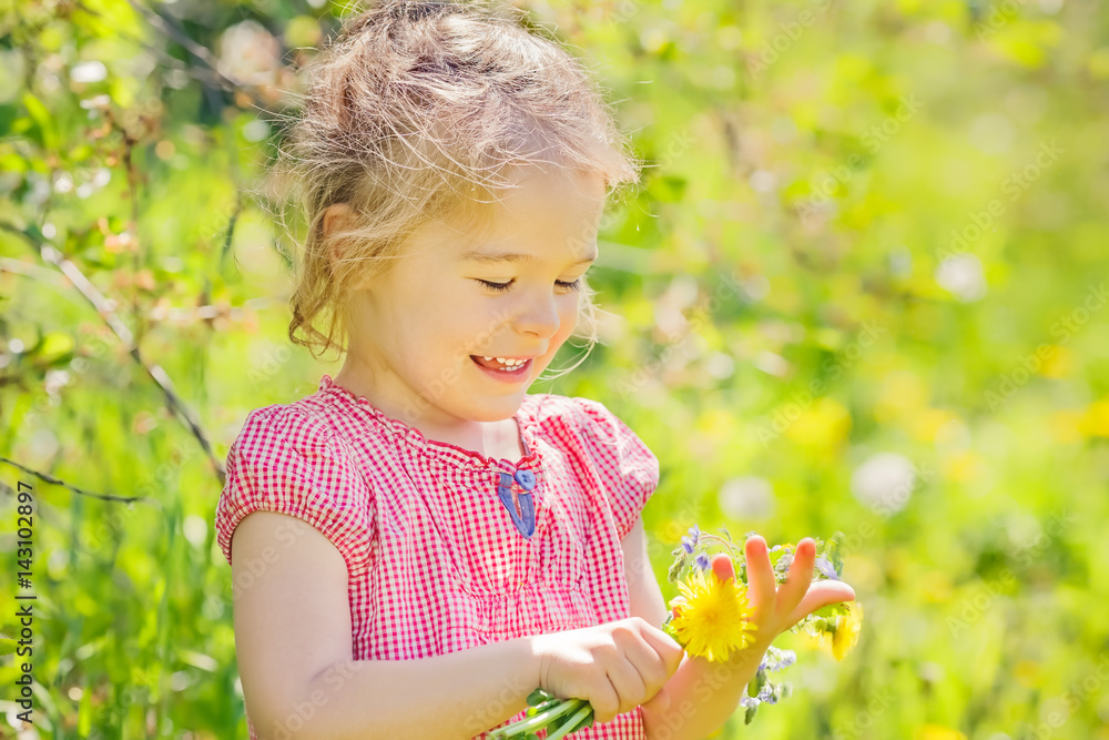 Happy little girl playing with bouquet in sunny park Happy little girl playing with bouquet in sunny park