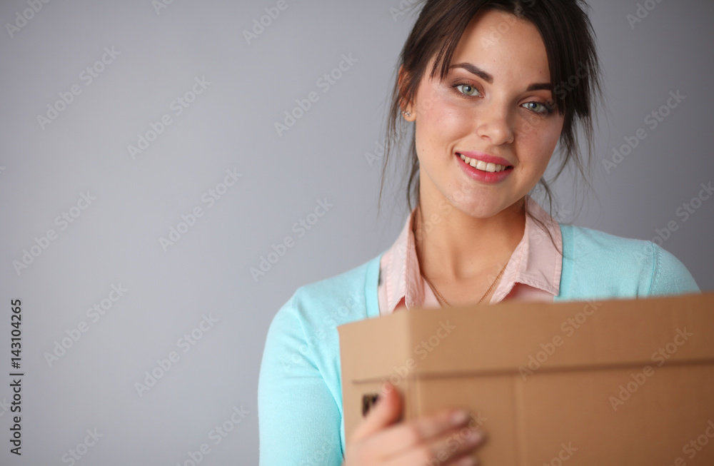Portrait of pretty woman holding a box Portrait of pretty woman holding a box