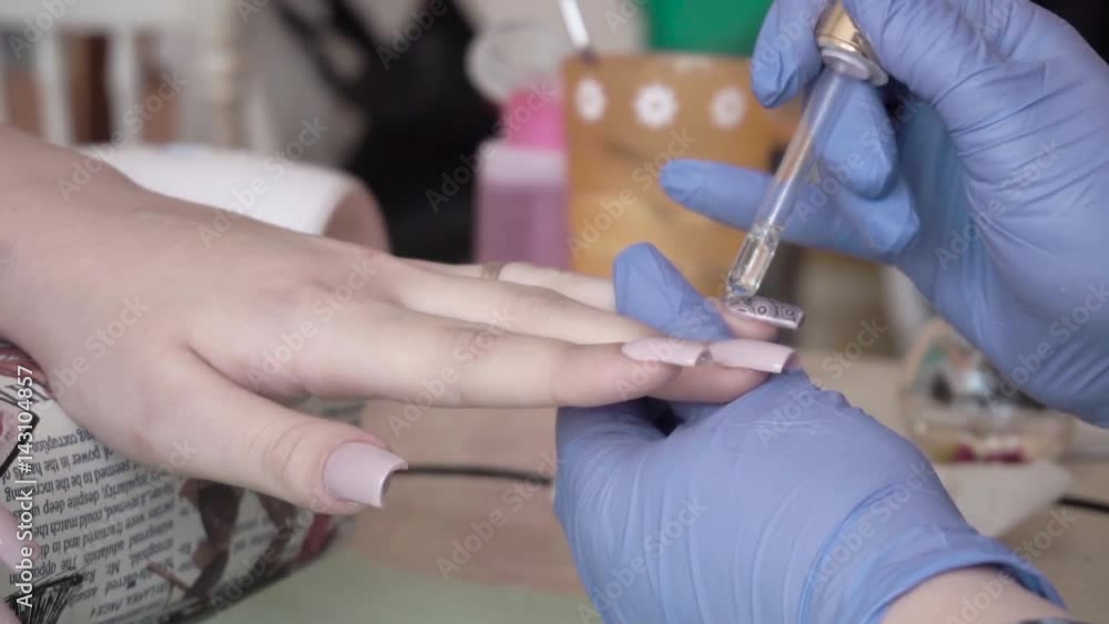 Slow motion Manicure nail care in a beauty salon. Cuticle oil care Slow motion Manicure nail care in a beauty salon. Cuticle oil care