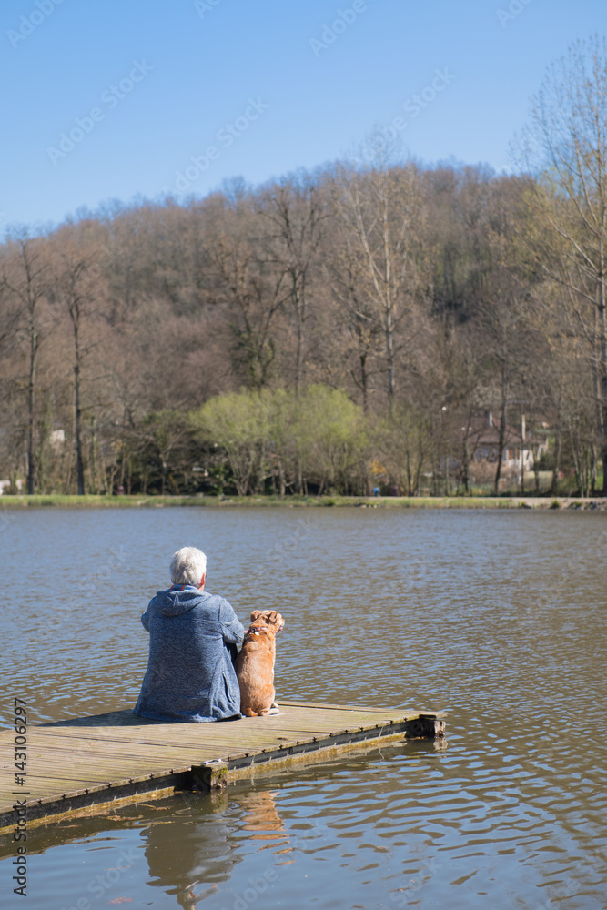 Man with dog on landing stage